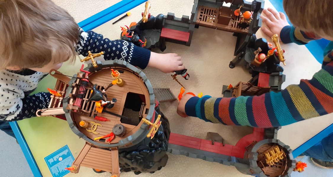 Spielszene von oben fotografiert, Kinder spielen mit einer Playmobil-Ritterburg