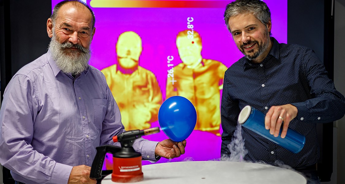 Zwei Forscher zeigen physikalische Experimente