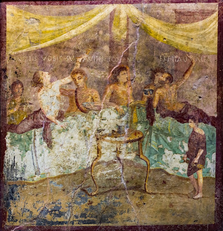 Fresko mit einer Symposionsszene aus Pompeji. Es stammt vermutlich aus dem ersten Jahrhundert nach Christus. Das Fresko beinhaltet eine Inschrift: Facitis vobis suaviter, ego canto.