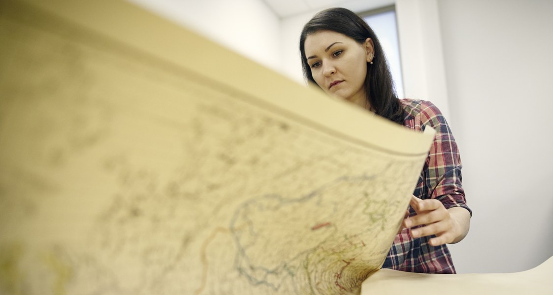 Eine Studentin betrachtet eine Karte zur Sprachgeographie