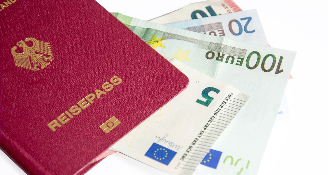 Deutscher Reisepass mit Geldscheinen.