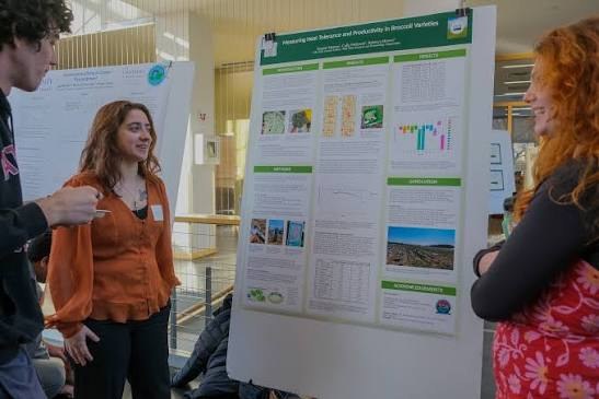 Two female Scienctist discuss an academic poster