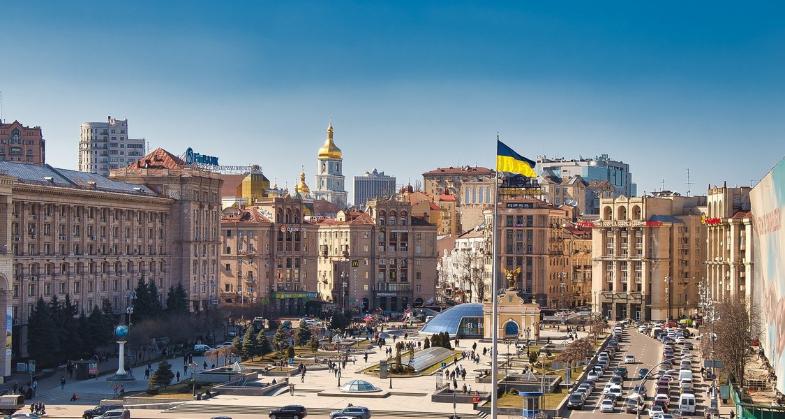 The picture shows a city in Ukraine and a Ukraine flag.