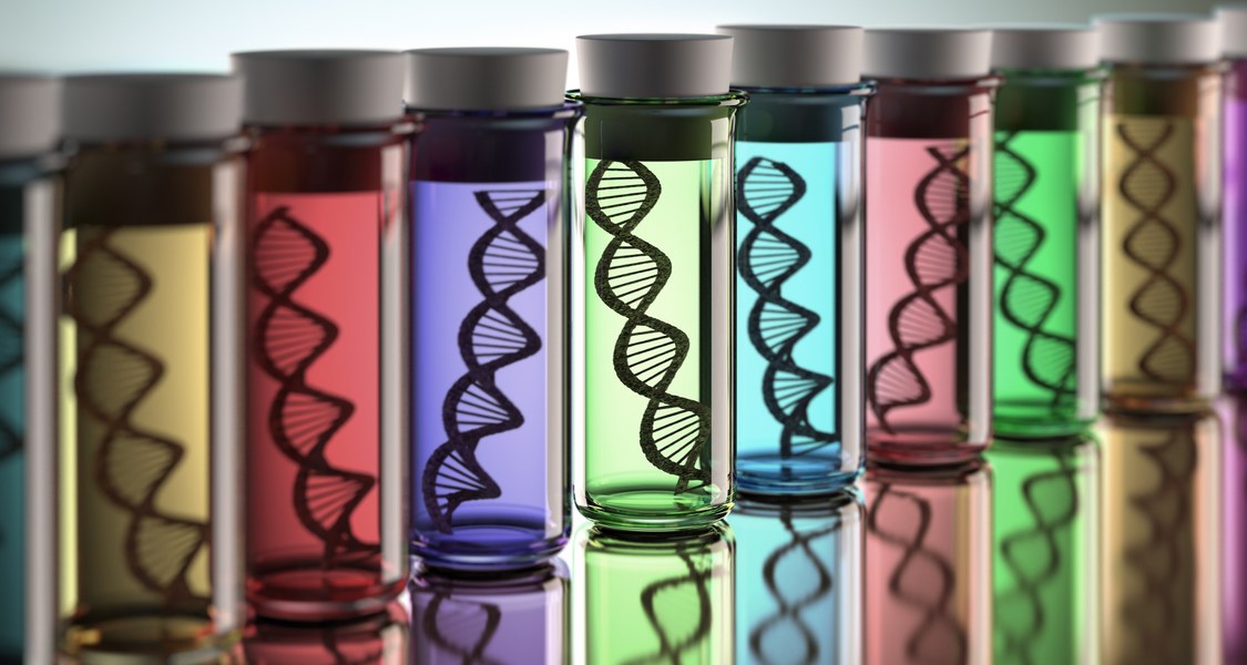 Several large colourful test tubes containing models of DNA double helixes.