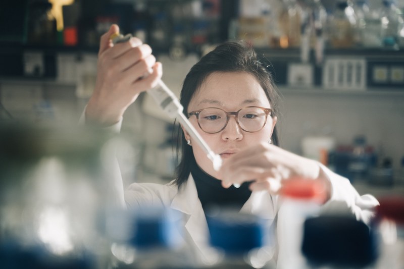 Researcher in lab with pipette