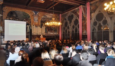 Professor Katharina Krause, president of Philipps University, giving her keynote in the crowded auditorium.