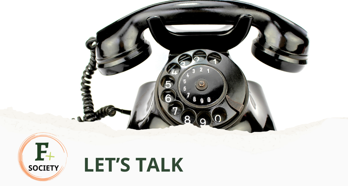 A black old-school telephone. At the bottom of the picture the text: Let's Talk