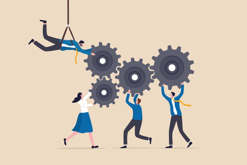 In the middle you can see four cogwheels that interlock. Below them are three cartoon characters holding three of the cogwheels upwards. A fourth cartoon character swings from the left on a rope and holds the fourth cogwheel from above.