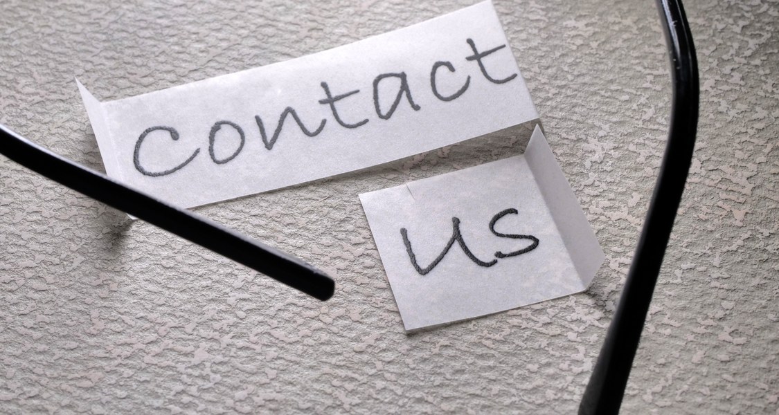 written piece of paper "contact us"