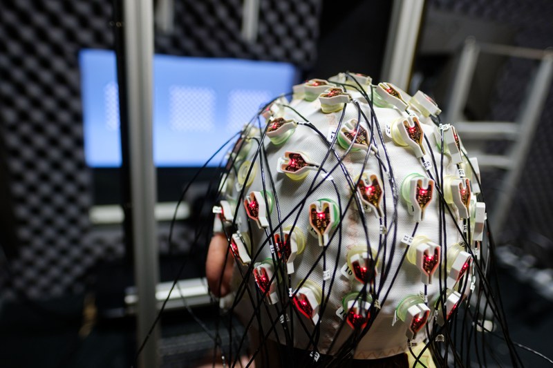 Person with EEG hood in an experimental situation