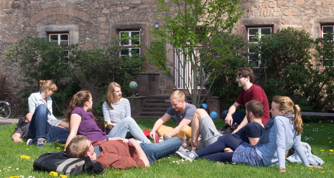 A group of students sitting in a park.