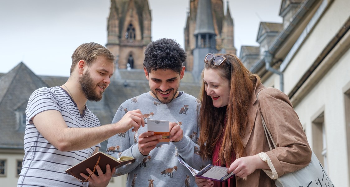 Students talking with a church in the background.